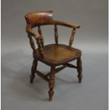 A child's 19th century elm and polished beech captains style chair with spindle back,