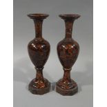 A pair of marble baluster vases with trumpet shaped necks and on circular spreading and hexagonal