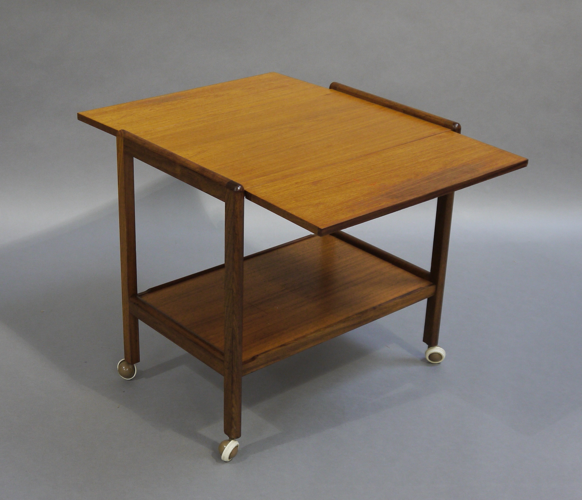 A teak trolley with single drop leaf and under tier on castors - Image 2 of 2