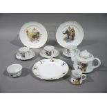 A doll's tea service printed with Jack and Jill nursery rhyme, comprising tea pot,