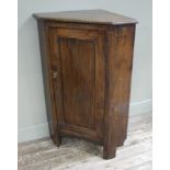 An oak corner cupboard with single door