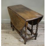 An oak oval gateleg table on barley twist and square framing