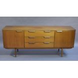 A 1960s teak 'Long John' sideboard having three drawers to the centre flanked by a cupboard to