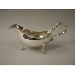 An Elizabeth II silver sauce boat of 18th century design having a cut and gadroon rim,