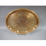 A large copper tray of oval outline foliate embossed to the centre with dragoon rim JS & SB to the