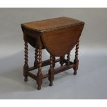 A mahogany oval drop leaf supper table on barley twist and square framing
