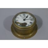 A brass cased ship's clock with white enamelled secondary dial with damage