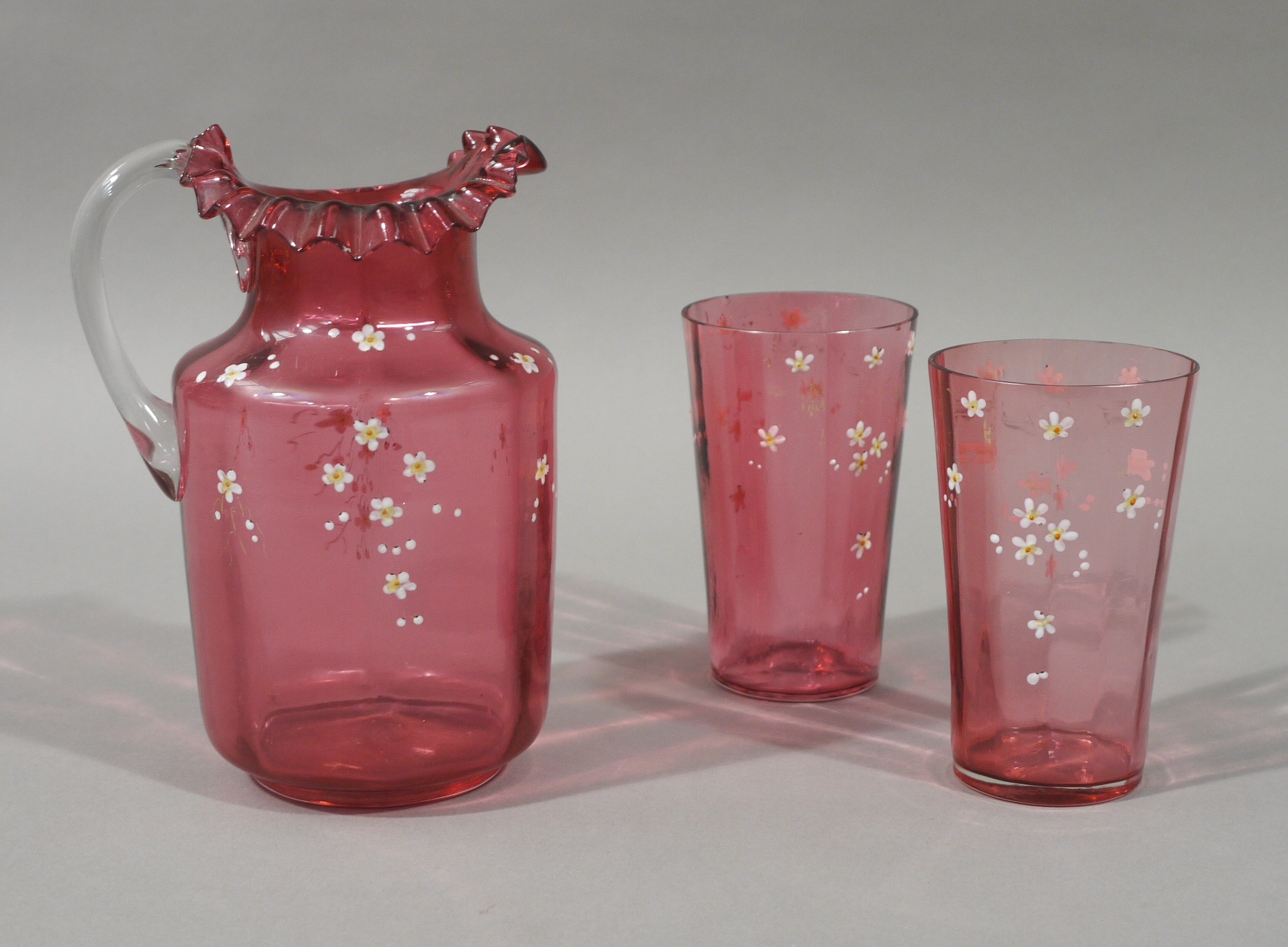 A Victorian cranberry glass jug and pair of matching tapered cylindrical beakers, - Image 2 of 2