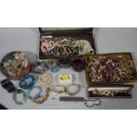 A quantity of costume jewellery in a tartan biscuit tin and two boxes