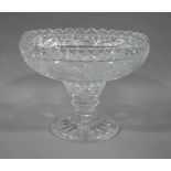 A heavily cut pedestal fruit dish having a scalloped rim above a knopped pedestal and circular star