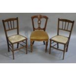 An Edwardian mahogany single dining chair with upholstered serpentine seat on turned legs together