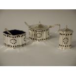 An Elizabeth II silver three piece cruet, on oval serpentine outline,