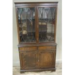 A reproduction mahogany and glazed bookcase cupboard