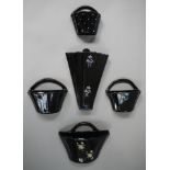 A pair of black lustrous glazed basket wall pockets,