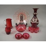 A collection of cranberry glass including, a jug, tumbler, pair of salts, four shot glasses,