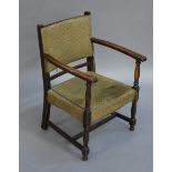 An early 20th century oak armchair with moquette upholstered back and seat,