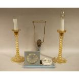 A pair of orange lustre glass candlesticks of bobbin columns, on a stepped circular base, 27.