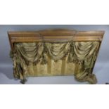 A Victorian walnut half-tester bed, the canopy having a cavetto shallow arch with stylised shelf,