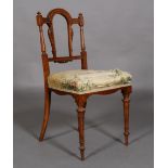 A Victorian walnut salon chair, with moulded arched open back,