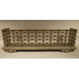 A Victorian cast iron fire kerb, having an oval trellis work guard above an egg and dart cast rim,