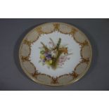 A Royal Worcester circular cabinet plate painted to the centre with a floral spray within a border