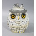 A Naples bisque porcelain lidded tankard moulded as a squat owl with glass eyes,