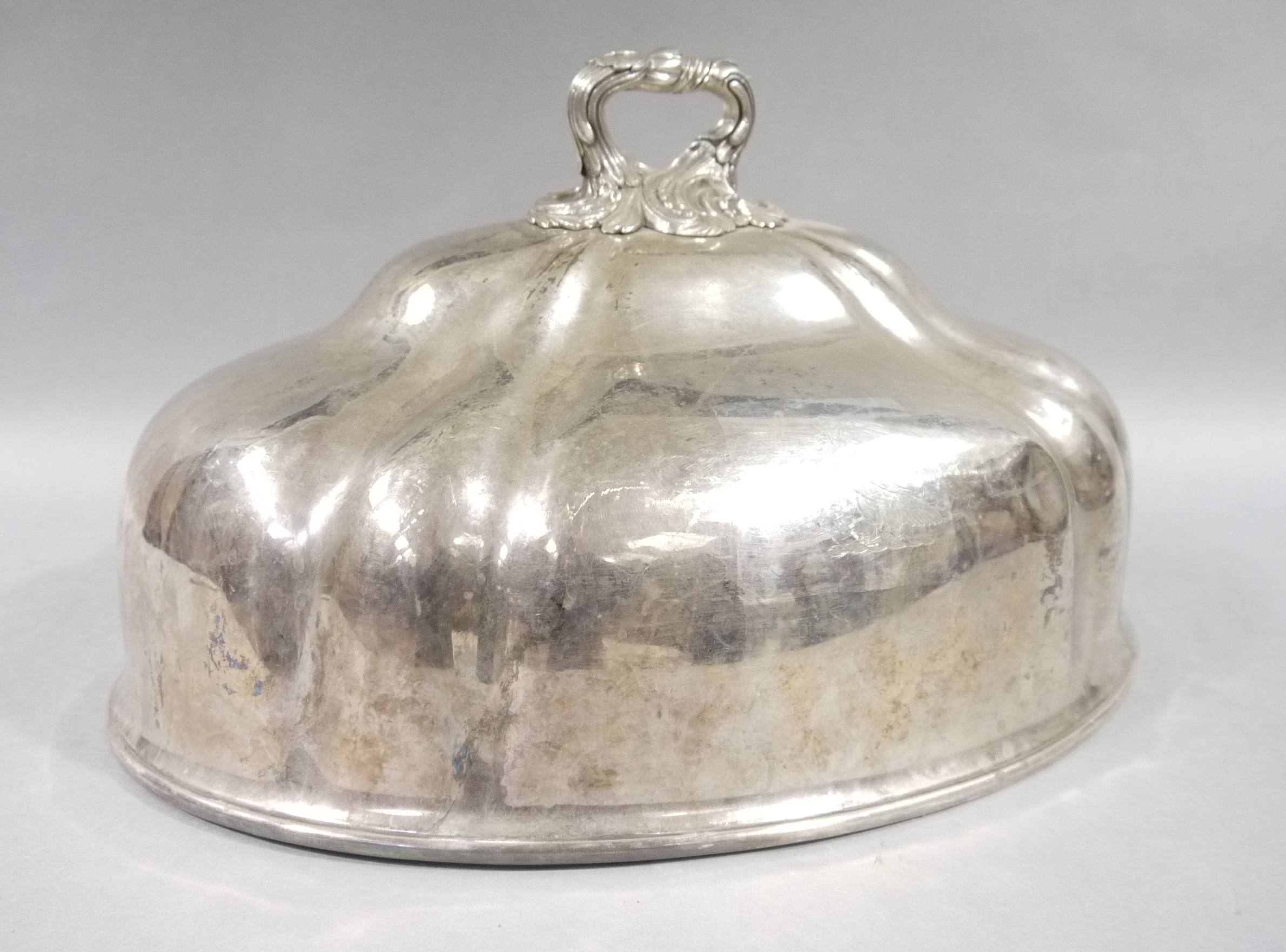 A Victorian silver plated lobed oval meat dish cover with foliate cast handle,