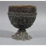 A late 19th century coloured metal filigree mounted coconut cup,