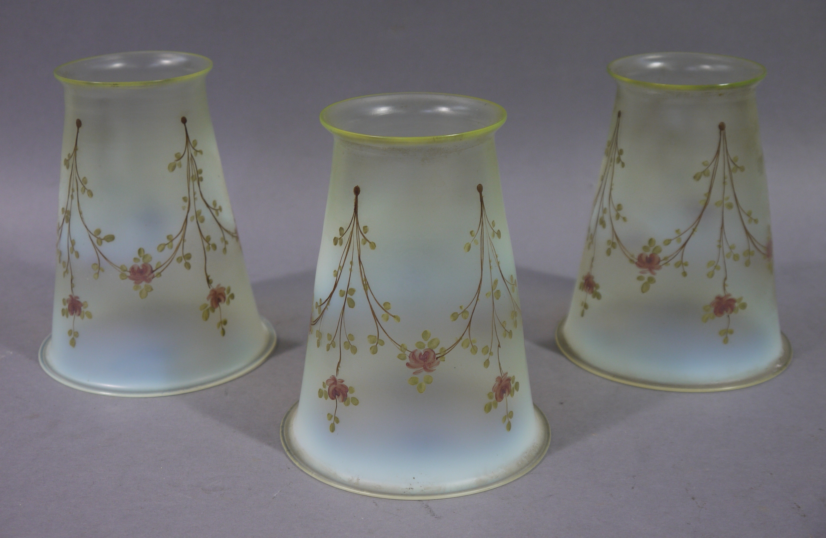 A set of three Victorian/Edwardian vaseline glass light shades of tapered cylindrical outline hand