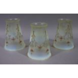 A set of three Victorian/Edwardian vaseline glass light shades of tapered cylindrical outline hand