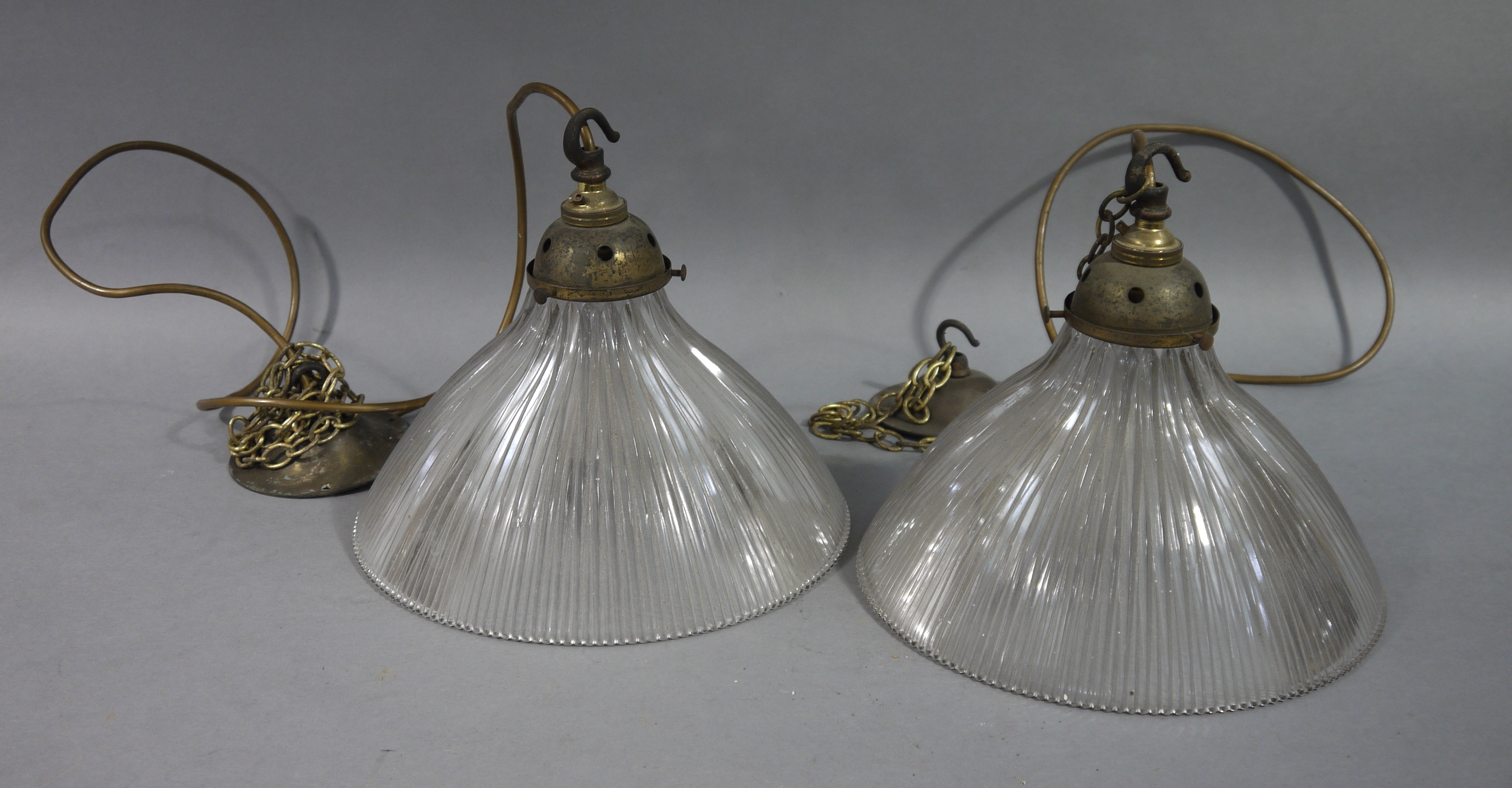 A pair of early 20th century holophane pendant lights, the glass shade, moulded with patent no.