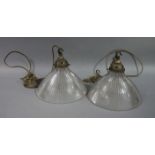 A pair of early 20th century holophane pendant lights, the glass shade, moulded with patent no.