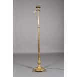 A late Victorian brass telescopic standard lamp with swagged drapery to the vase shape column on a
