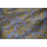 A pair of blue and gold printed curtains, valance and a tie back,