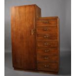 An oak veneered wardrobe, having a single door flanked by a drop side fitted with seven drawers,