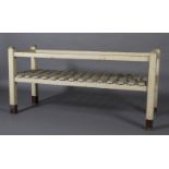 An early 20th century painted pine slatted rack with rail, on square legs,
