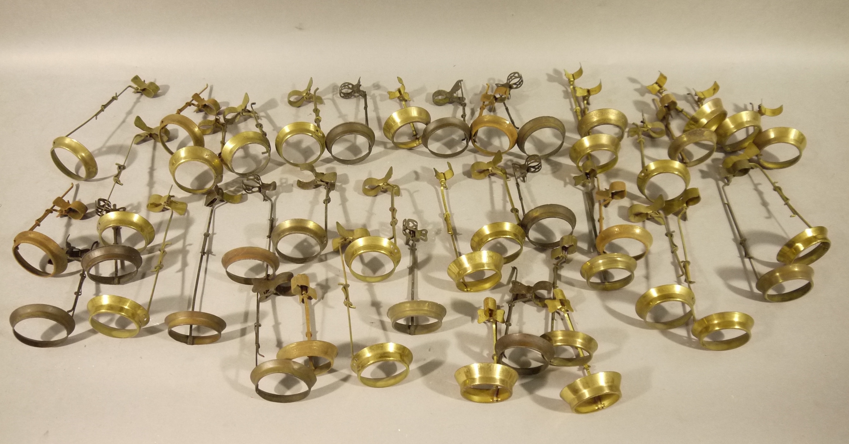 Forty-two gilt metal candle shade fittings with clips