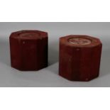 A pair of octagonal wooden stands, covered deep red velvet, lead bases,