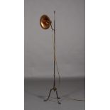 An oxidised copper reading lamp having a circular shade with everted rim on adjustable curved arm,