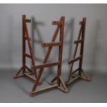 A set of three brown painted estate made game hangers of A-Frame,