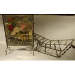 A painted mirror firescreen with brass frame together with a wrought iron log rack