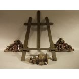 A pair of Victorian mahogany furniture crestings of foliate scroll design, and a finial,