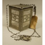 An Arts and Crafts planished pewter and opaque glass lantern of square outline and integral hanging
