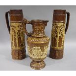 A garniture of three continental pottery jugs,