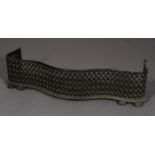 A 19th century steel serpentine fender of trellis design, on compressed bun feet,