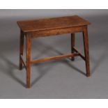 An early 20th century mahogany stool, rounded rectangular, on square framing,