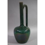 An Ault/Linthorpe jug of bottle shape with tall neck and handle, lustrous dark green glaze,