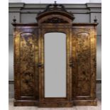 A mid Victorian figured and painted walnut breakfront wardrobe carved urn and broken arch pediment,