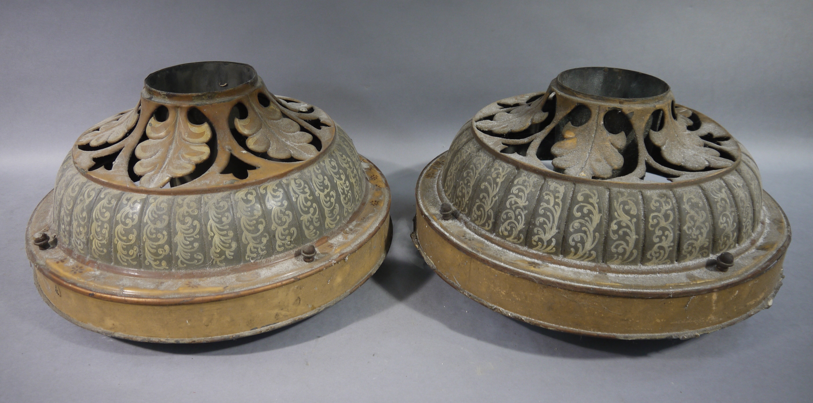 A pair of Victorian painted metal ceiling lights of circular domed outline with a pierced leaf