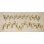 A set of nineteen brass curtain tie back hooks with beaded rims,